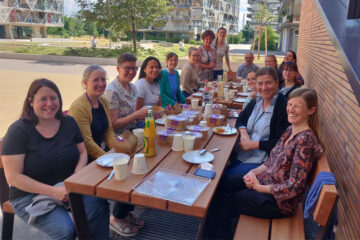 Kevin Laland and the women in bioscience group at the University of Vienna sitting outside on a picnic bench